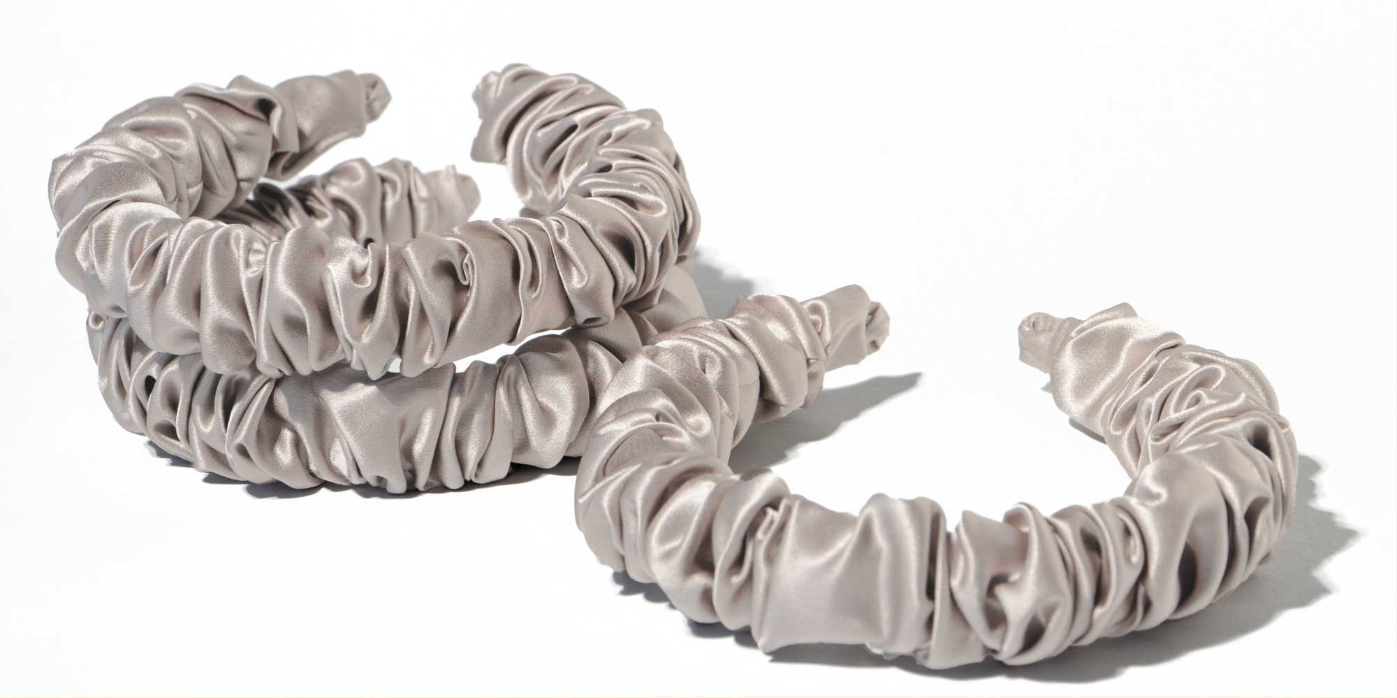 eclat beige premium silk headbands on a plain background