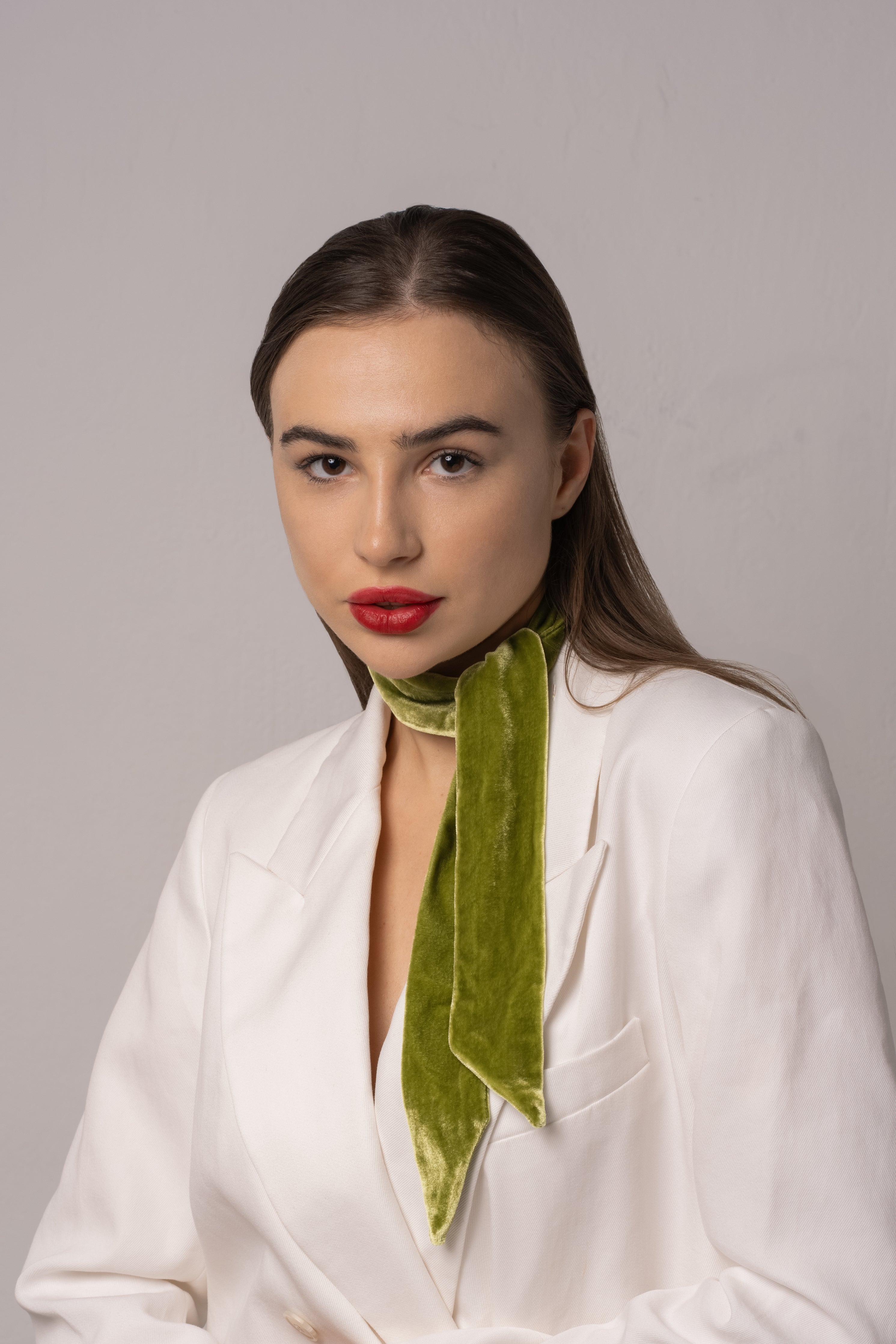 fashion model wearing a green velvet neck wrap