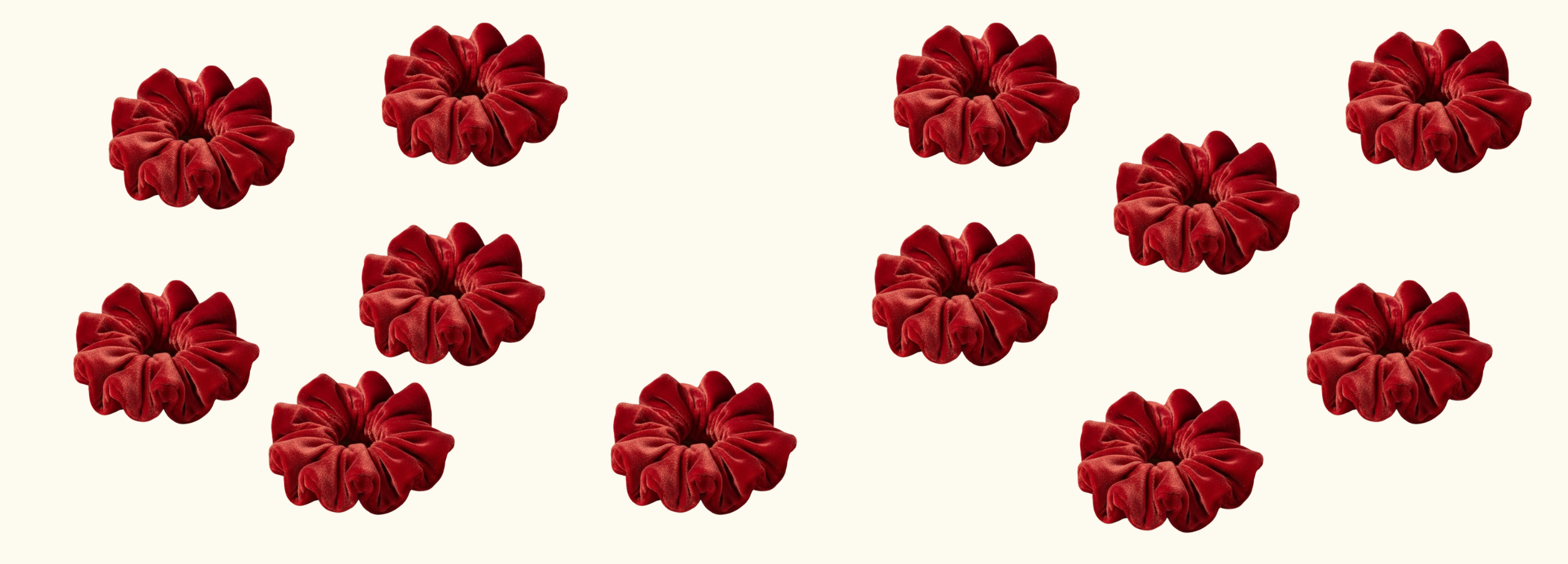 a collection of the montreux red velvet scrunchies on a plain background